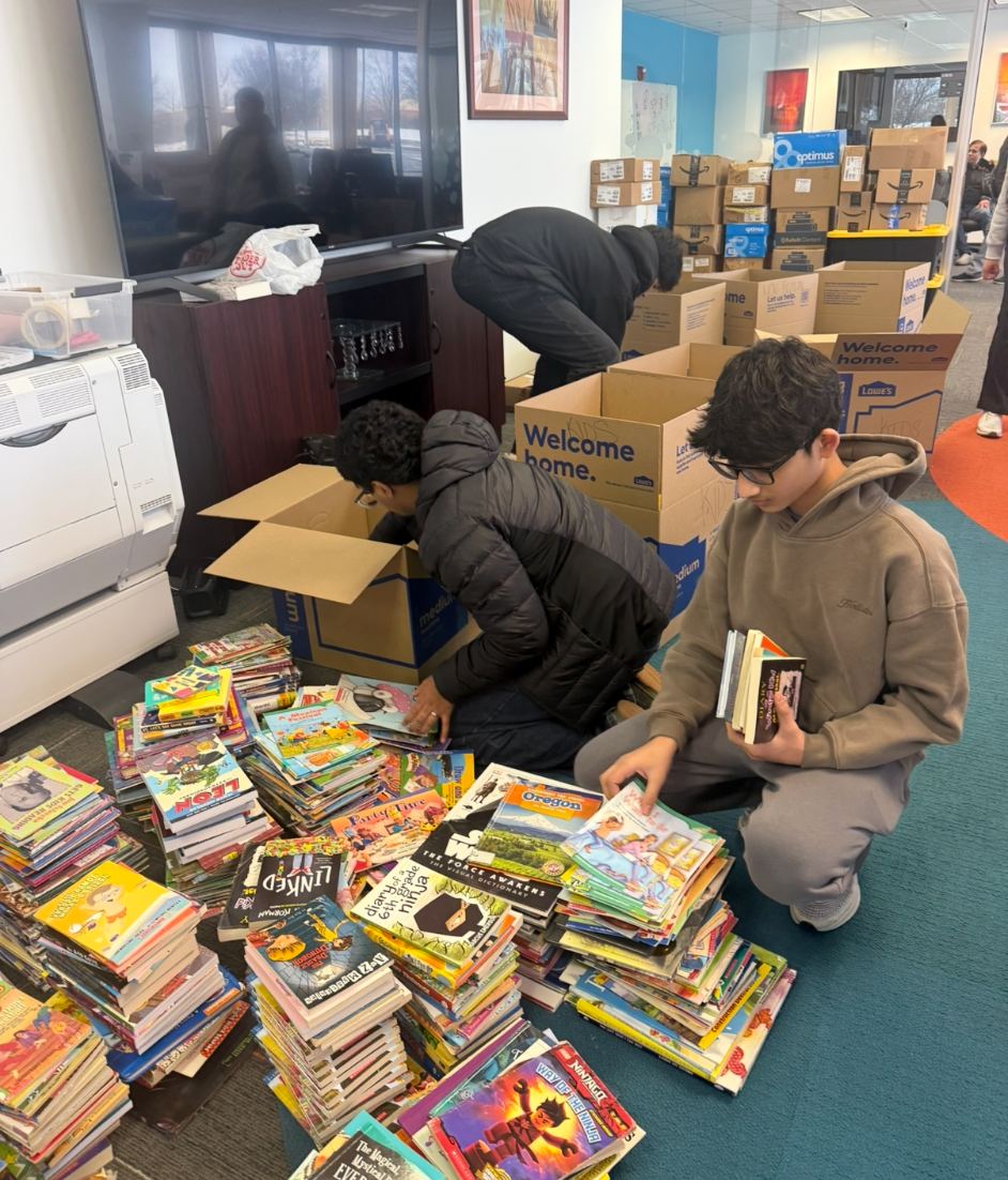 Volunteers sorting books into piles