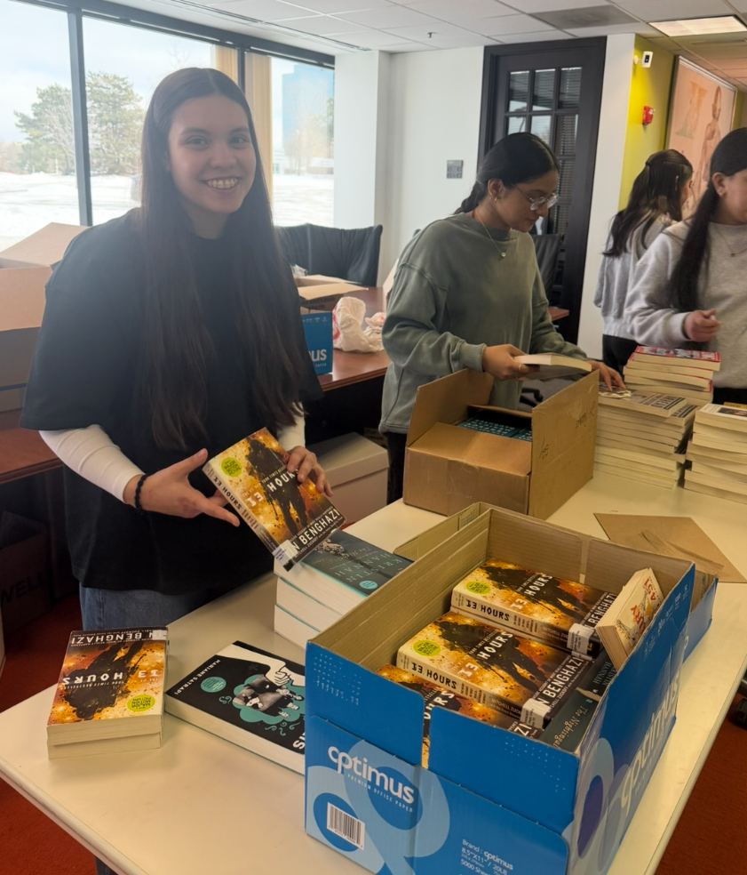 Volunteer holding a donated book